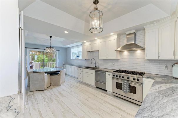 Dining room, Interior, Kitchen, Pendant Lights, Recessed Lighting, Stainless Steel Appliances, Wood Texture Flooring