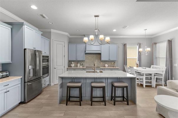 Chandelier, Dining room, Interior, Kitchen, Pendant Lights, Recessed Lighting, Stainless Steel Appliances, Wood Texture Flooring