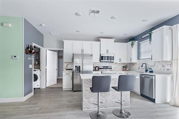 Interior, Kitchen, Recessed Lighting, Stainless Steel Appliances, Washer, Wood Texture Flooring