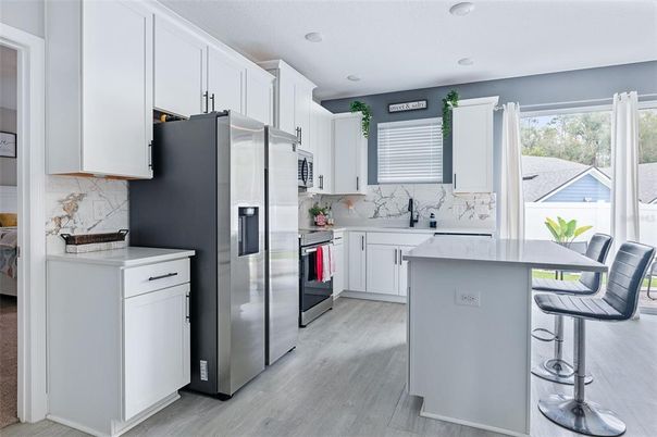 Interior, Kitchen, Marble Walls, Recessed Lighting, Stainless Steel Appliances, Wood Texture Flooring