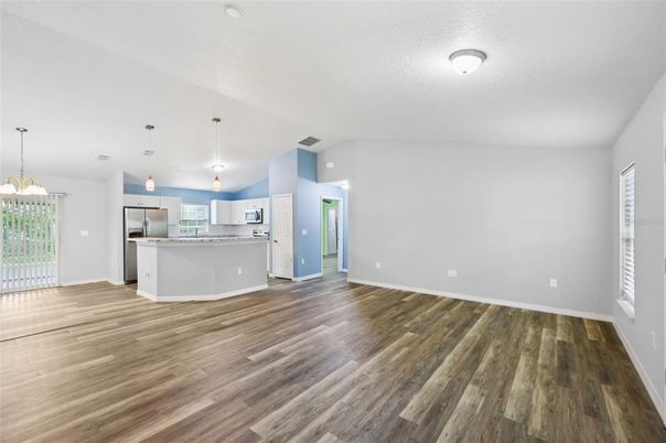 Empty room, Interior, Kitchen, Pendant Lights, Stainless Steel Appliances, Wood Texture Flooring