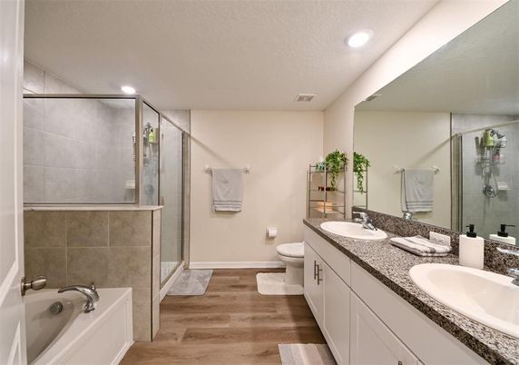 Bathroom, Dual Sink Vanities, Glass Shower, Interior, Recessed Lighting, Wood Texture Flooring