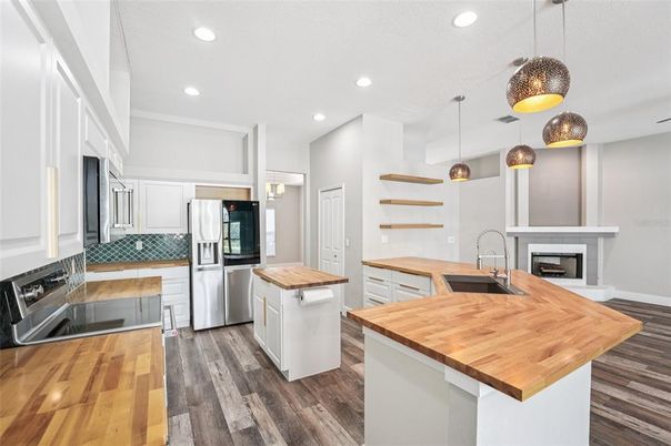Fireplace, Interior, Kitchen, Pendant Lights, Recessed Lighting, Stainless Steel Appliances, Wood Texture Flooring