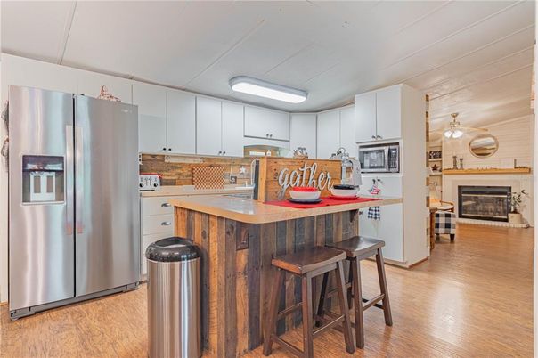 Fireplace, Interior, Kitchen, Stainless Steel Appliances, Wood Texture Flooring