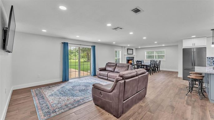 Dining room, Fireplace, Interior, Kitchen, Living room, Pendant Lights, Recessed Lighting, Stainless Steel Appliances, Wood Texture Flooring