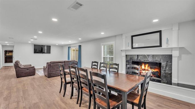 Dining room, Fireplace, Interior, Projection Screen, Recessed Lighting, Wood Texture Flooring