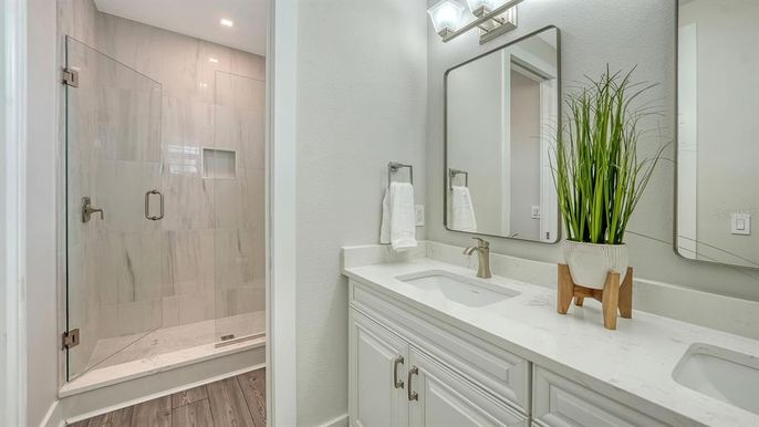 Bathroom, Dual Sink Vanities, Glass Shower, Interior, Recessed Lighting, Wood Texture Flooring