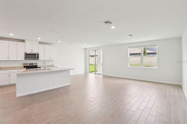 Empty room, Interior, Kitchen, Recessed Lighting, Stainless Steel Appliances, Wood Texture Flooring