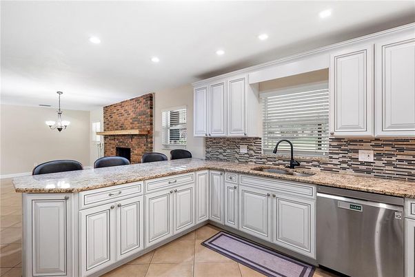 Fireplace, Interior, Kitchen, Pendant Lights, Recessed Lighting, Stainless Steel Appliances, Stone Walls