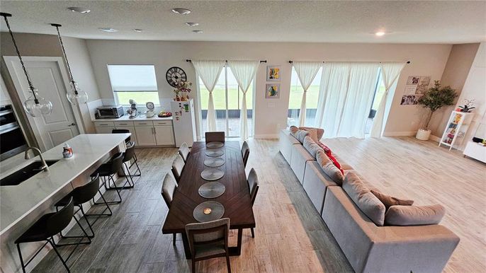 Dining room, Interior, Kitchen, Living room, Recessed Lighting, Water, Wood Texture Flooring