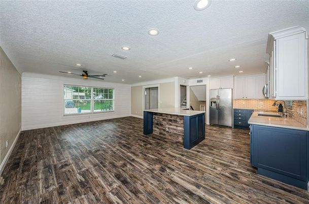 Empty room, Interior, Kitchen, Recessed Lighting, Stainless Steel Appliances, Wood Texture Flooring