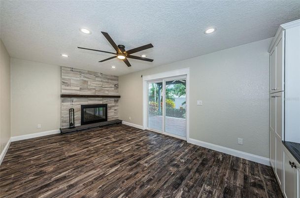 Empty room, Fireplace, Interior, Recessed Lighting, Stone Walls, Wood Texture Flooring