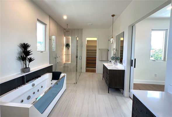 Bathroom, Dual Sink Vanities, Glass Shower, Interior, Pendant Lights, Recessed Lighting, Wood Texture Flooring