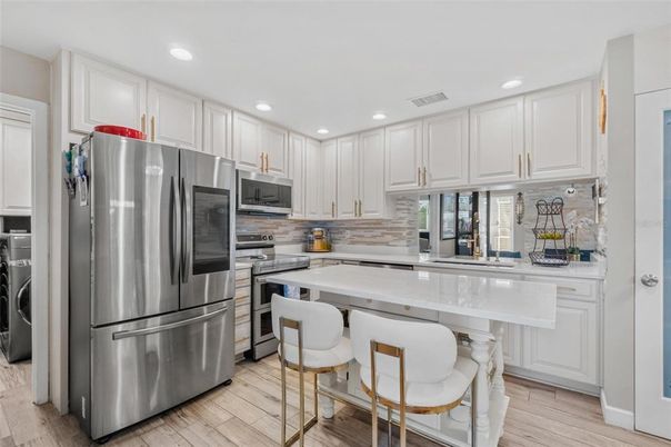 Interior, Kitchen, Recessed Lighting, Stainless Steel Appliances, Washer, Wood Texture Flooring