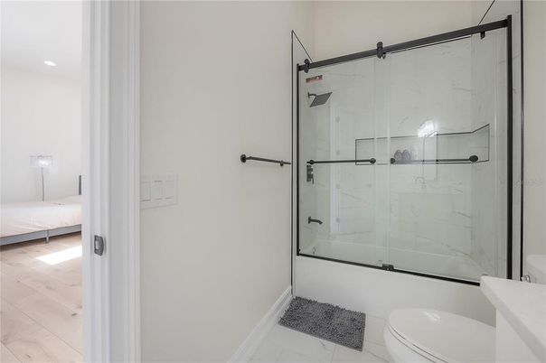 Bathroom, Glass Shower, Interior, Marble Walls, Recessed Lighting, Wood Texture Flooring