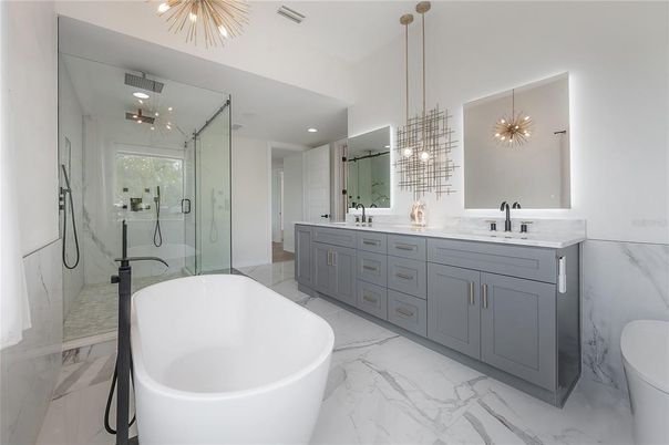 Bathroom, Dual Sink Vanities, Free Standing Baths, Glass Shower, Interior, Marble, Marble Walls, Pendant Lights, Recessed Lighting