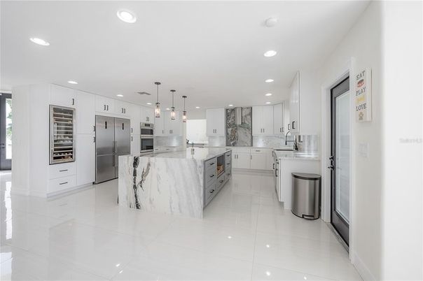 Interior, Kitchen, Marble Walls, Pendant Lights, Recessed Lighting, Stainless Steel Appliances