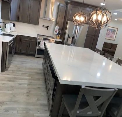 Chandelier, Interior, Kitchen, Pendant Lights, Recessed Lighting, Stainless Steel Appliances, Wood Texture Flooring