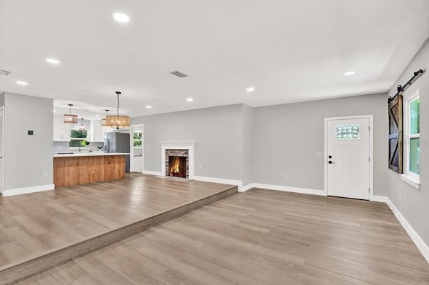 Empty room, Fireplace, Interior, Kitchen, Pendant Lights, Recessed Lighting, Wood Texture Flooring