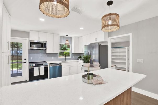 Chandelier, Interior, Kitchen, Pendant Lights, Recessed Lighting, Stainless Steel Appliances, Wood Texture Flooring