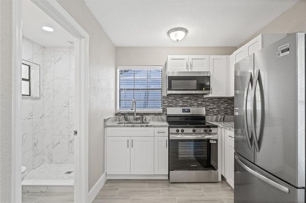 Interior, Kitchen, Marble, Marble Walls, Recessed Lighting, Stainless Steel Appliances, Wood Texture Flooring