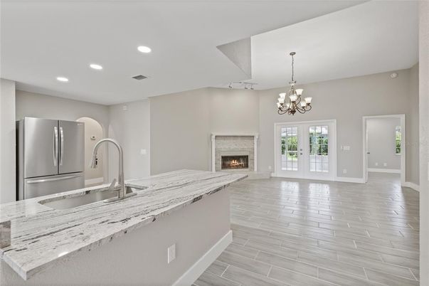 Chandelier, Fireplace, Interior, Kitchen, Recessed Lighting, Wood Texture Flooring