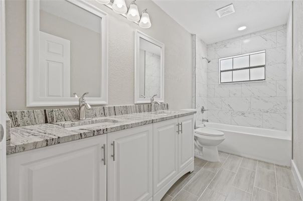 Bathroom, Dual Sink Vanities, Interior, Marble Walls, Recessed Lighting, Wood Texture Flooring
