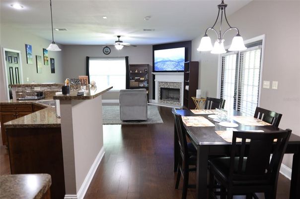 Dining room, Fireplace, Interior, Living room, Pendant Lights, Recessed Lighting, Wood Texture Flooring