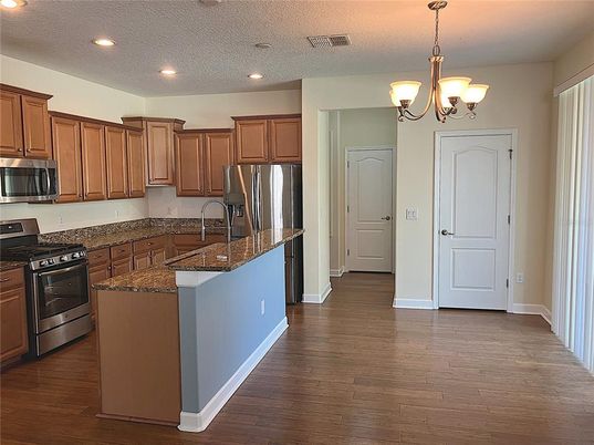 Chandelier, Interior, Kitchen, Pendant Lights, Recessed Lighting, Stainless Steel Appliances, Wood Texture Flooring