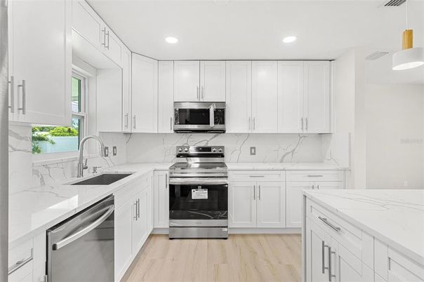 Interior, Kitchen, Marble Walls, Recessed Lighting, Stainless Steel Appliances, Wood Texture Flooring