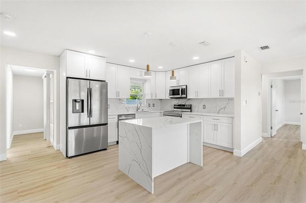 Interior, Kitchen, Marble Walls, Pendant Lights, Recessed Lighting, Stainless Steel Appliances, Wood Texture Flooring