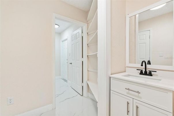 Bathroom, Dual Sink Vanities, Interior, Marble, Recessed Lighting, Walk-in Closets