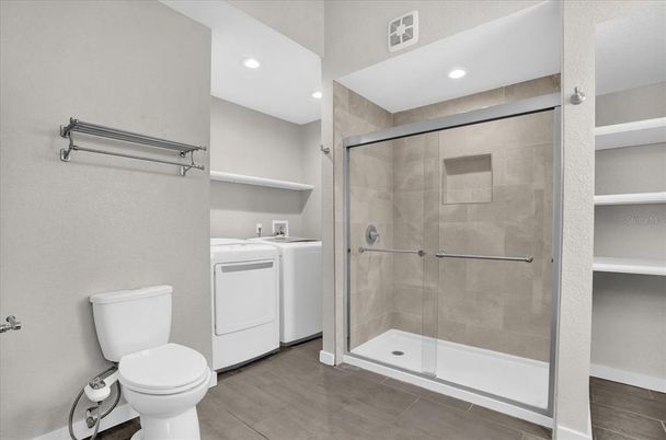 Bathroom, Glass Shower, Interior, Recessed Lighting, Washer, Wood Texture Flooring