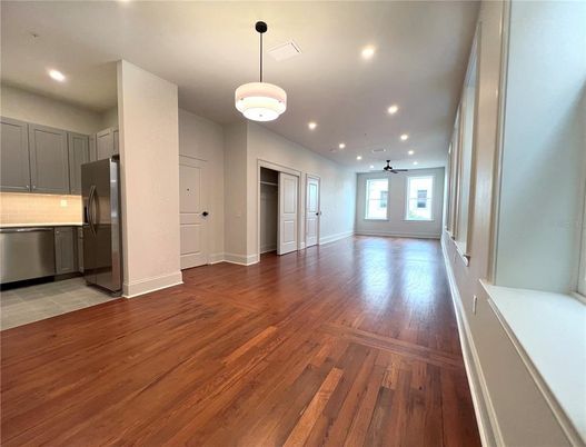 Empty room, Interior, Kitchen, Pendant Lights, Recessed Lighting, Stainless Steel Appliances, Wood Texture Flooring