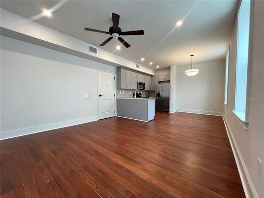 Empty room, Interior, Kitchen, Pendant Lights, Recessed Lighting, Stainless Steel Appliances, Wood Texture Flooring
