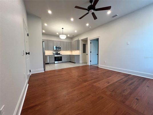 Chandelier, Empty room, Interior, Kitchen, Recessed Lighting, Stainless Steel Appliances, Wood Texture Flooring