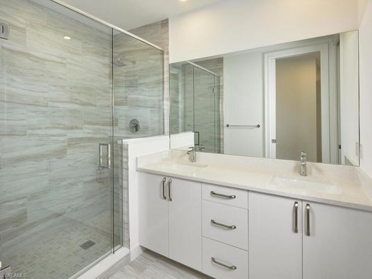 Bathroom, Dual Sink Vanities, Glass Shower, Interior, Marble Walls, Recessed Lighting