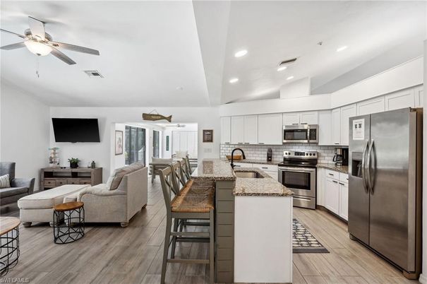 Dining room, Interior, Kitchen, Living room, Recessed Lighting, Stainless Steel Appliances, Wood Texture Flooring