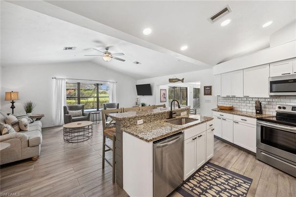 Dining room, Interior, Kitchen, Living room, Recessed Lighting, Stainless Steel Appliances, Wood Texture Flooring