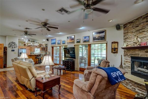 Fireplace, Interior, Kitchen, Living room, Recessed Lighting, Stone Walls, Wood Texture Flooring