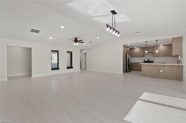 Empty room, Interior, Kitchen, Pendant Lights, Recessed Lighting, Stainless Steel Appliances, Wood Texture Flooring