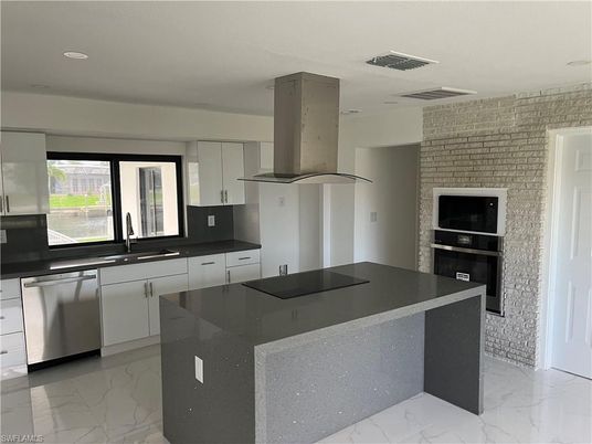 Interior, Kitchen, Marble, Recessed Lighting, Stainless Steel Appliances, Stone Walls