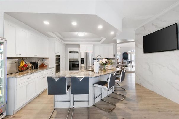 Interior, Kitchen, Marble Walls, Recessed Lighting, Stainless Steel Appliances, Wood Texture Flooring