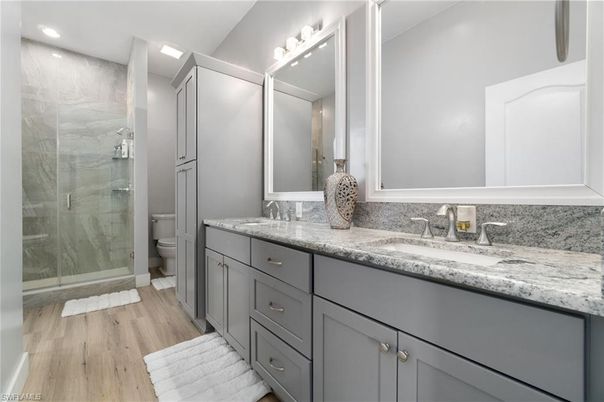 Bathroom, Dual Sink Vanities, Glass Shower, Interior, Recessed Lighting, Wood Texture Flooring