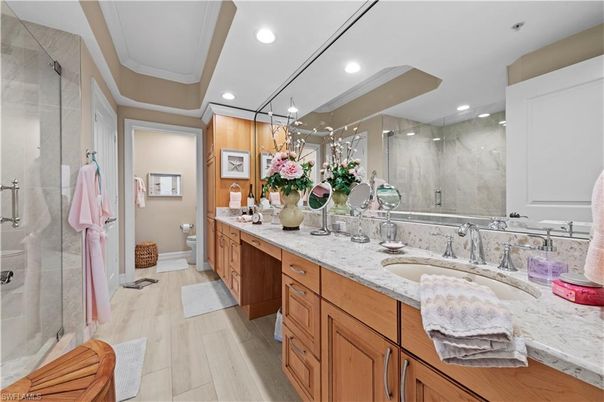 Bathroom, Dual Sink Vanities, Glass Shower, Interior, Marble Walls, Recessed Lighting, Wood Texture Flooring