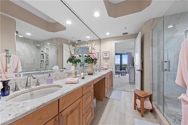 Bathroom, Dual Sink Vanities, Glass Shower, Interior, Marble Walls, Recessed Lighting, Wood Texture Flooring