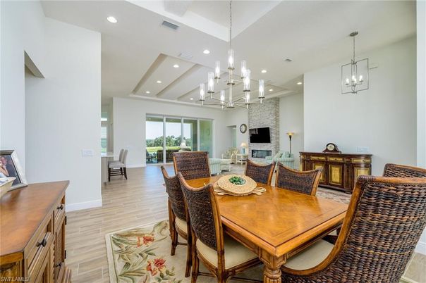 Chandelier, Dining room, Fireplace, Interior, Living room, Pendant Lights, Recessed Lighting, Wood Texture Flooring