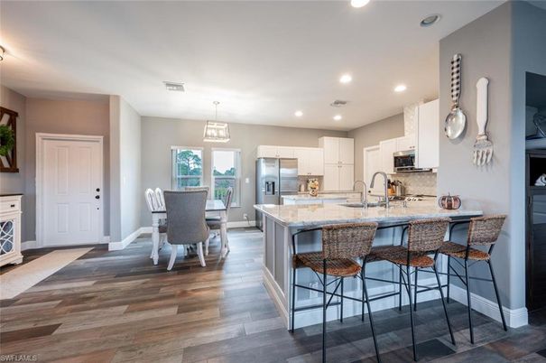 Dining room, Interior, Kitchen, Pendant Lights, Recessed Lighting, Stainless Steel Appliances, Wood Texture Flooring
