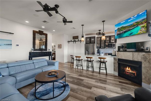 Fireplace, Interior, Kitchen, Living room, Pendant Lights, Recessed Lighting, Stainless Steel Appliances, Wood Texture Flooring