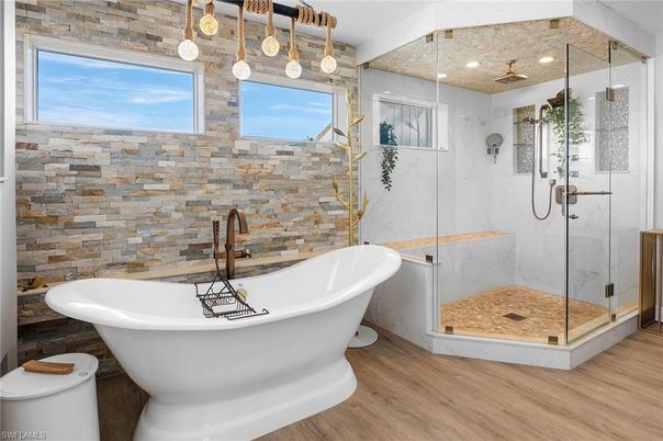Bathroom, Free Standing Baths, Glass Shower, Interior, Marble Walls, Pendant Lights, Recessed Lighting, Wood Texture Flooring